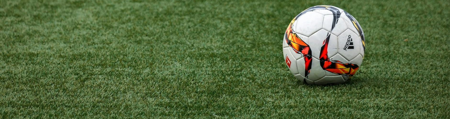white adidas soccer ball on grass