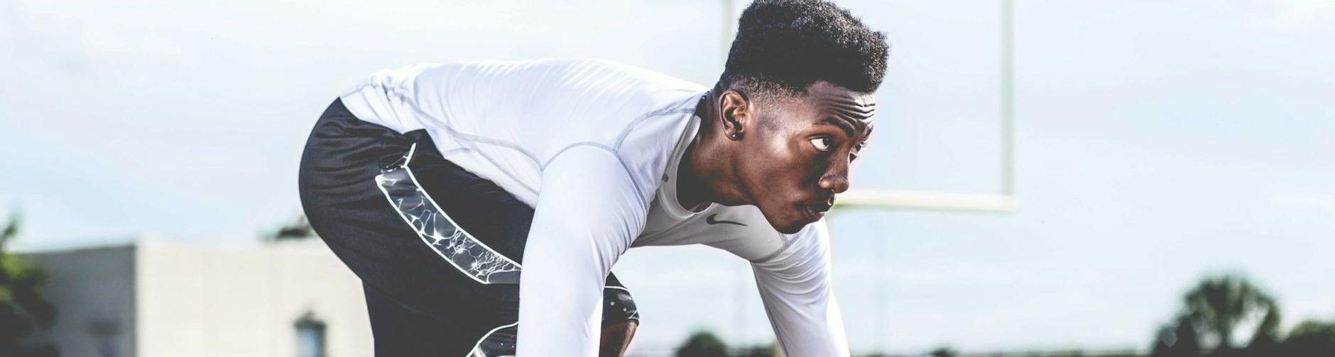 Mental Performance man wearing white sweater and black shorts about to run
