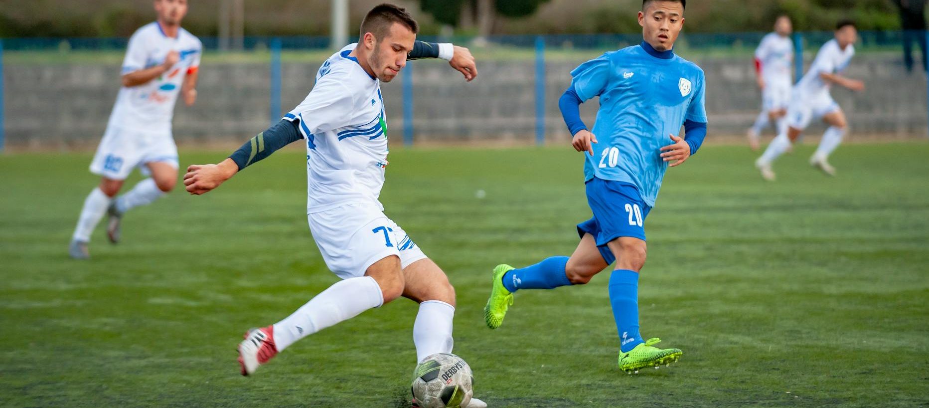 man wearing blue shirt looking on ball