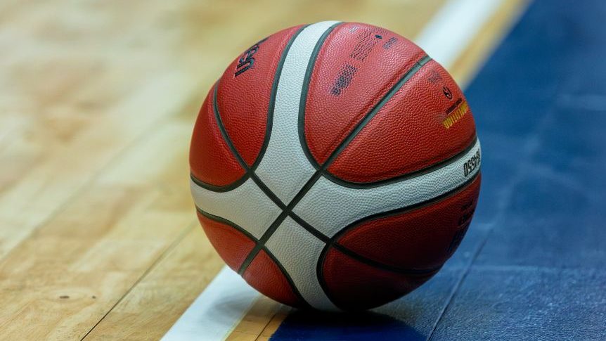 close up of a basketball on a hardwood court