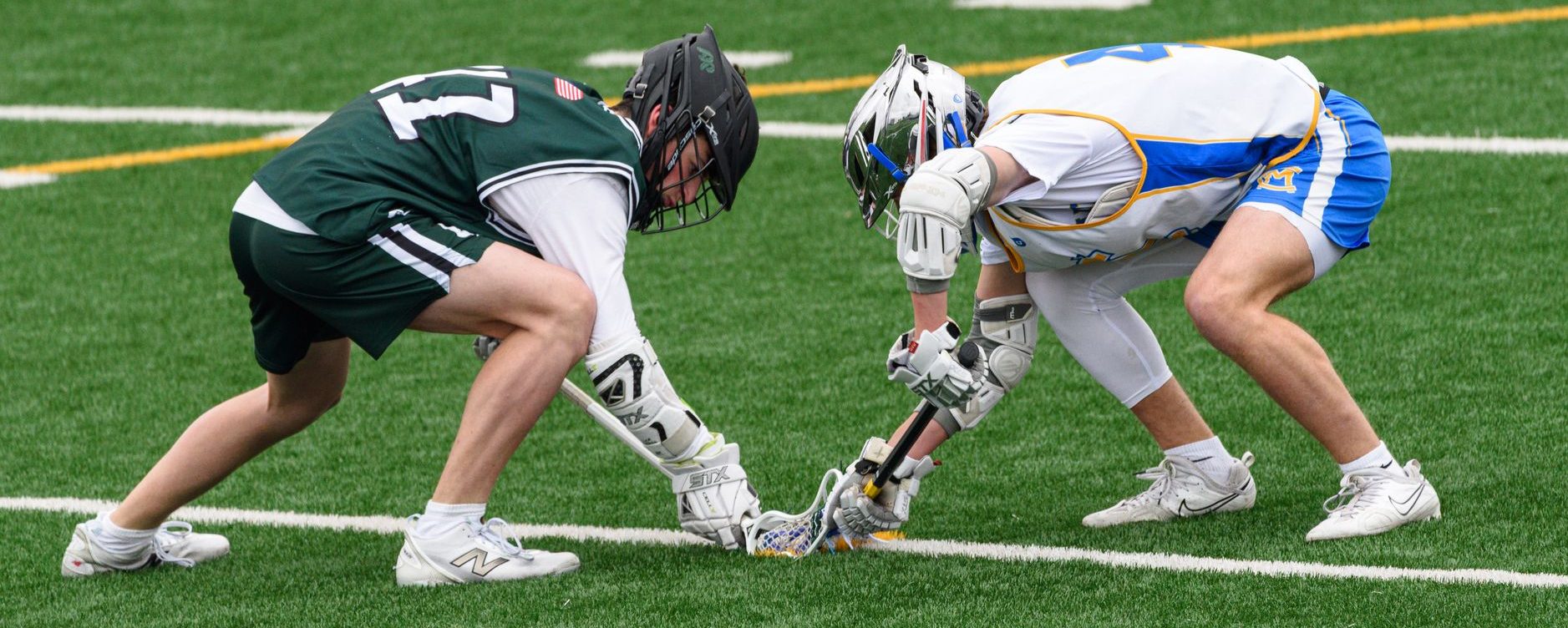 intense lacrosse face off scene on field